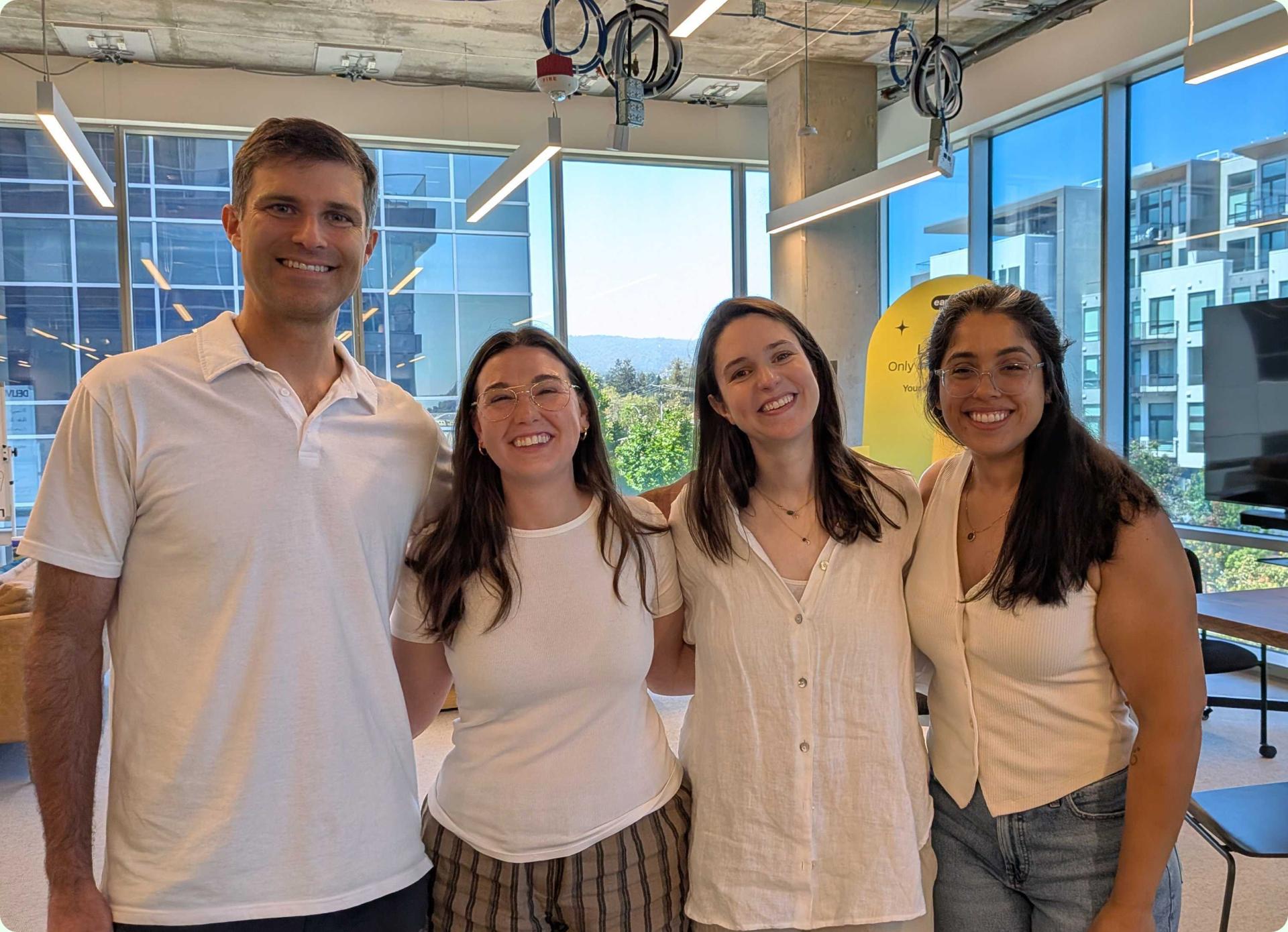 Four EarnIn teammates standing together in the Mountain View office