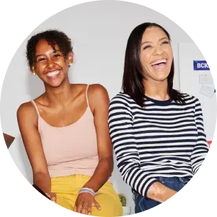 Two EarnIn customers smiling together